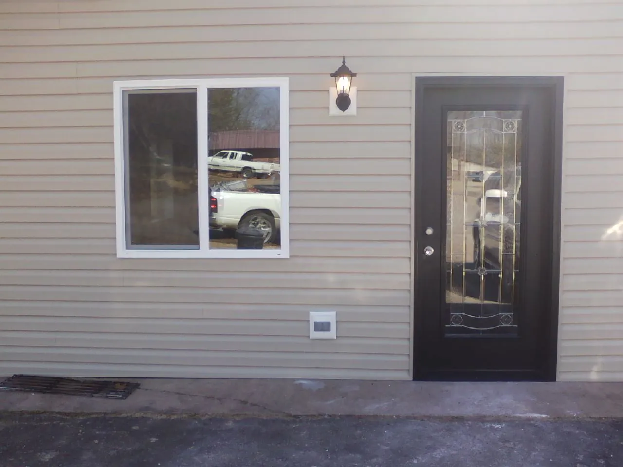 New siding, window and entry door on the side of an addition in Seibert