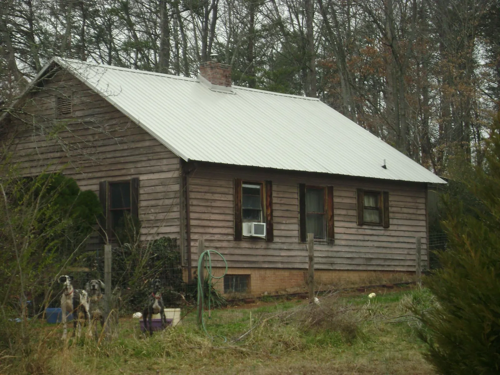 White metal roof on an old wood sided farmhouse, from a Metal Roof Installation job in Seibert